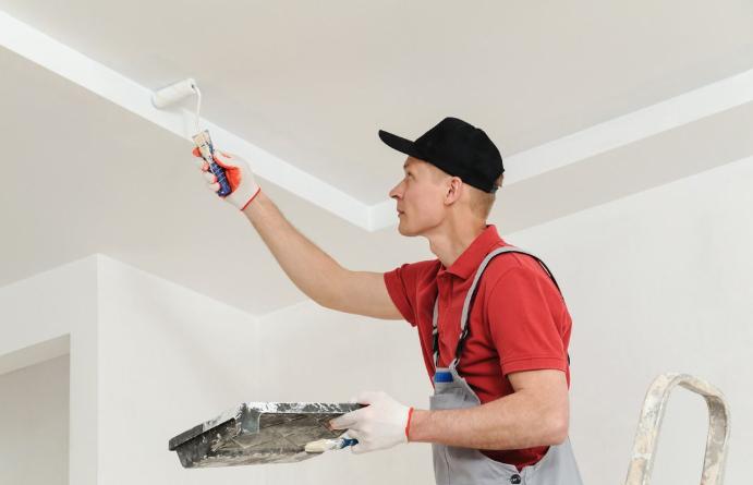 man applying moisture-resistant paint